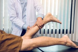Healthcare provider examining calf muscle for fascial restrictions