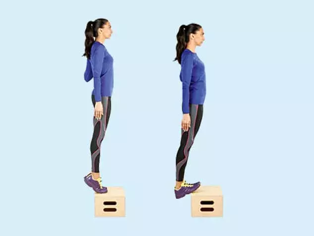 Person performing eccentric heel drop exercise for Achilles tendinopathy rehabilitation