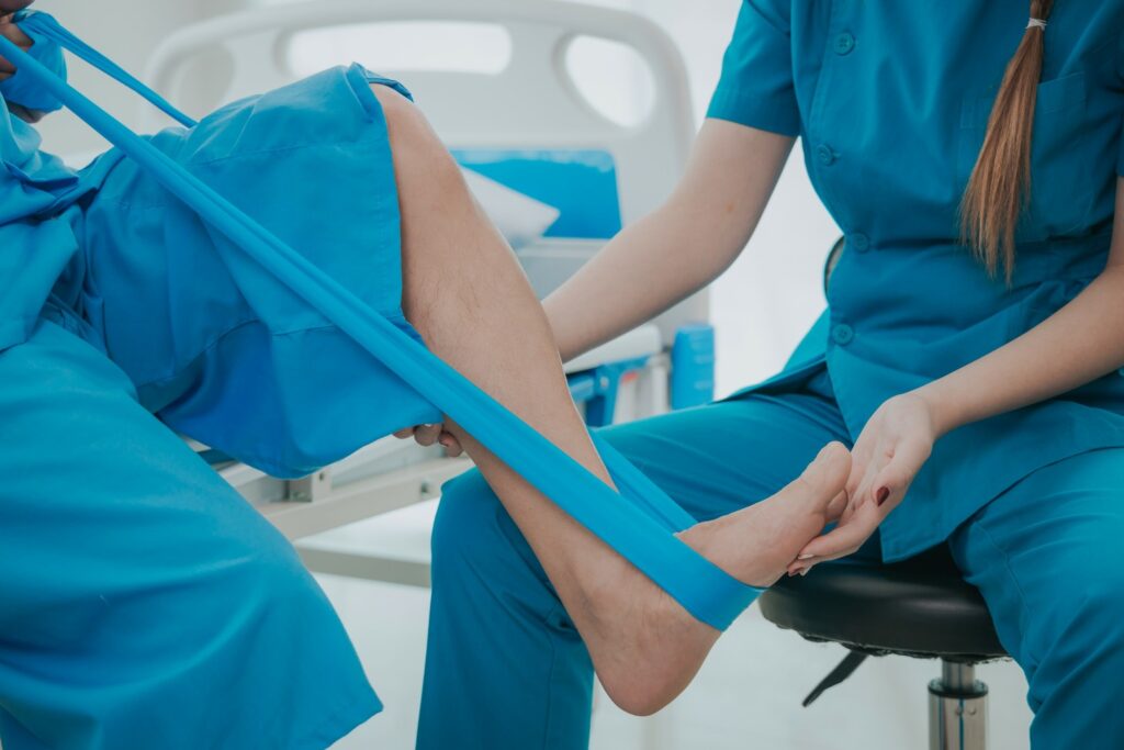 Physical therapist guiding patient through Achilles tendon rehabilitation exercises